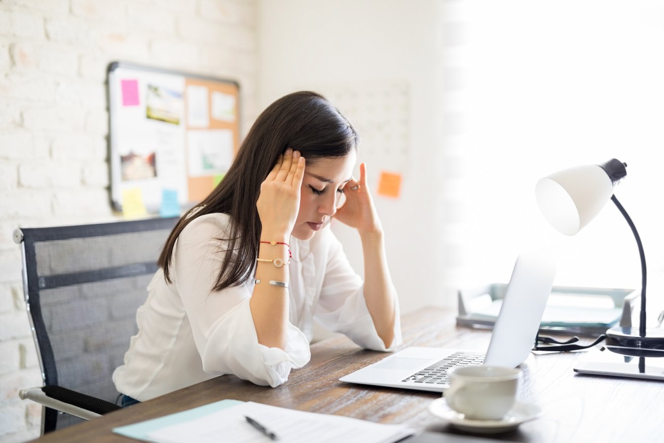 Woman with Hands on Her Head at the Office 